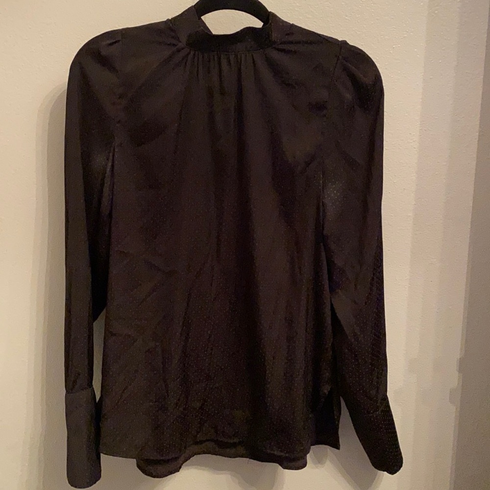 Black silky top with polka dots.